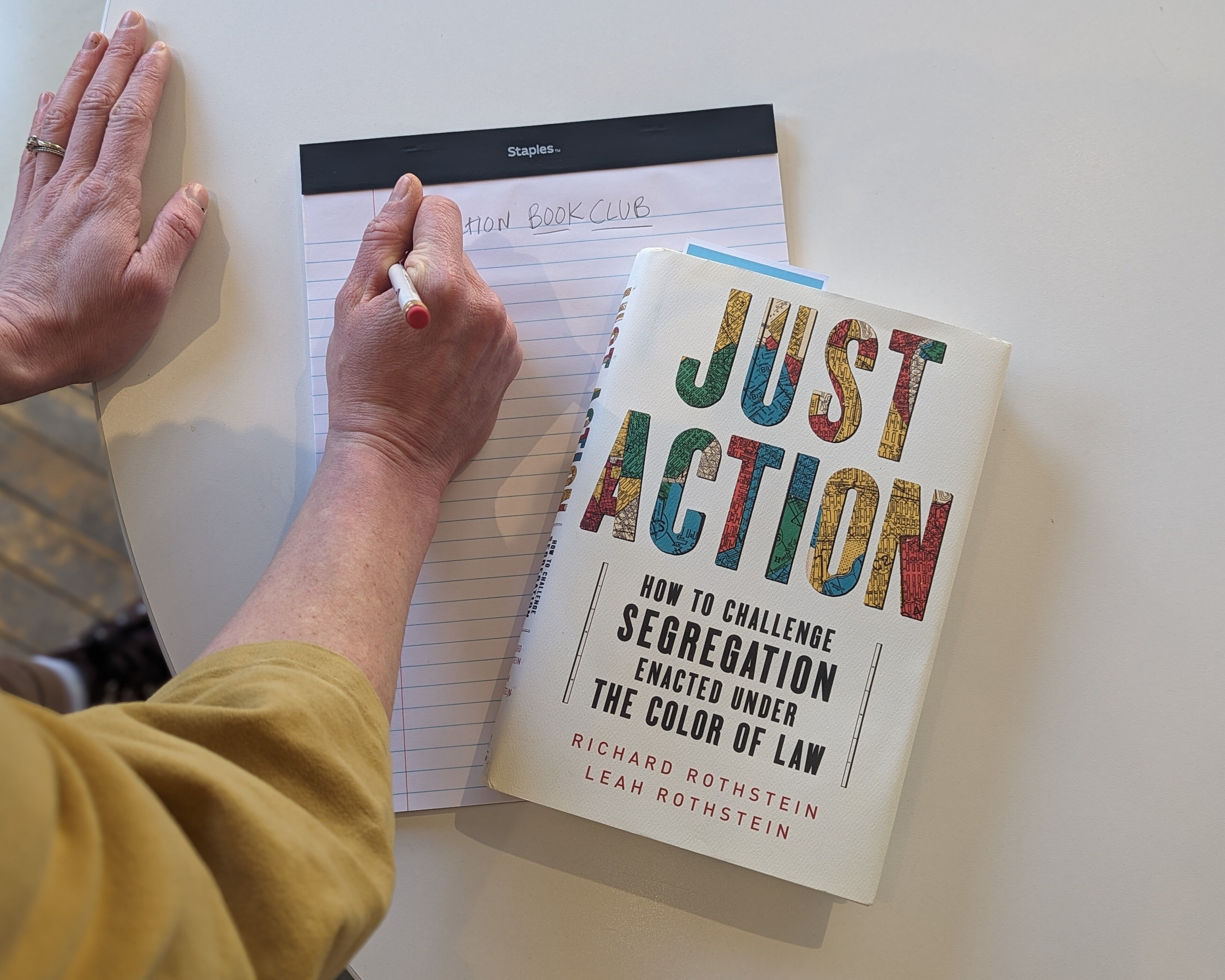 Photo of Just Action book and notepad with "Book Club" written on front